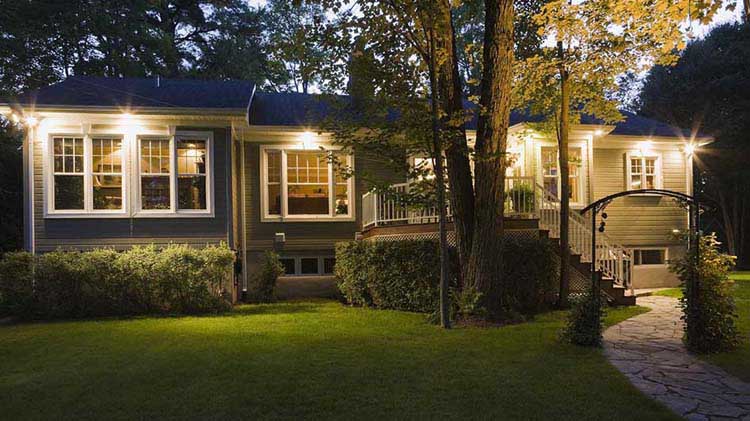 House at dusk with outdoor lights on