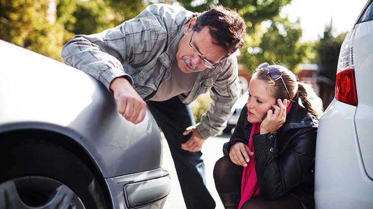 Woman calling her insurance company to report vehicle damage.