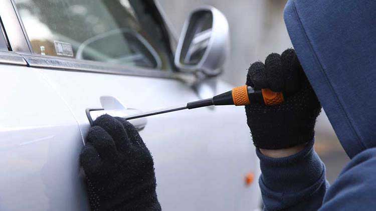 Person breaking into a car.