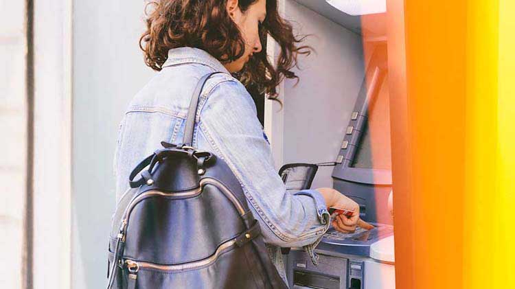 Woman using an ATM.