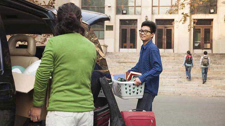 Mom helping son move into dorm.