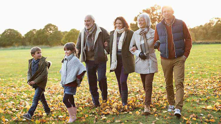 A multigenerational family walking outside.