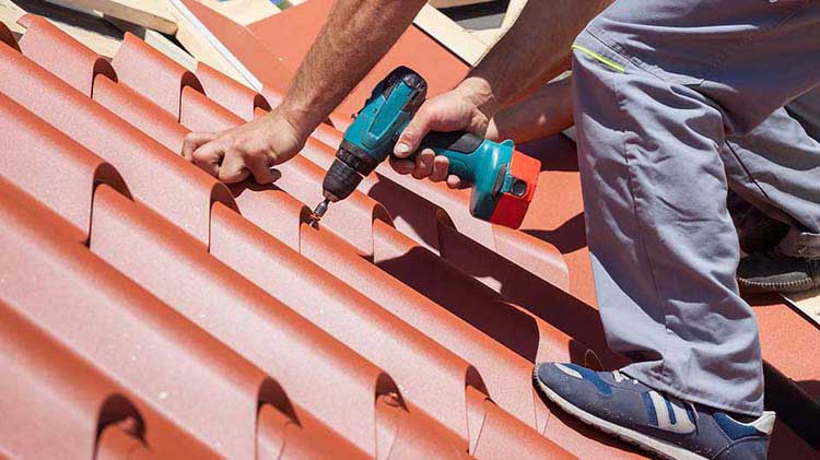 Man installing a metal roof.