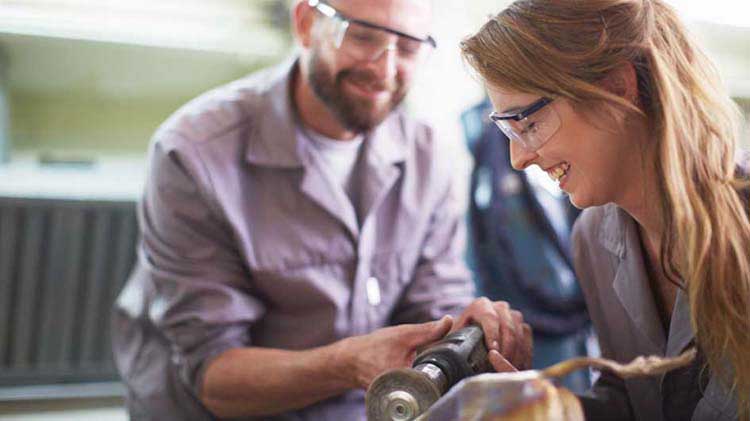 Man and woman wearing goggles working.