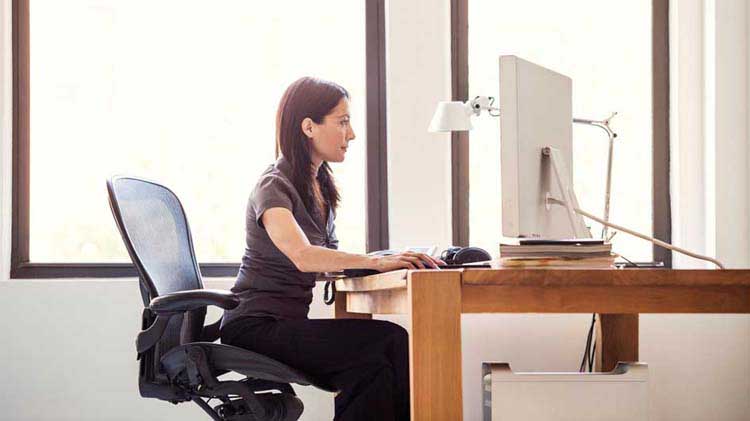 Woman sitting at desk typing