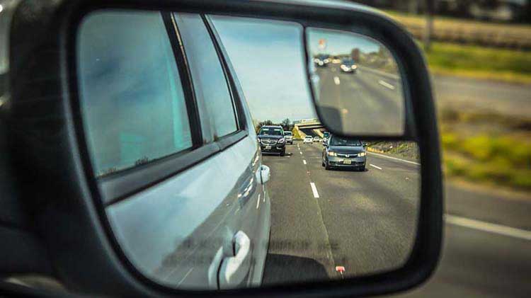 Side mirror view of cars behind you as you are merging.