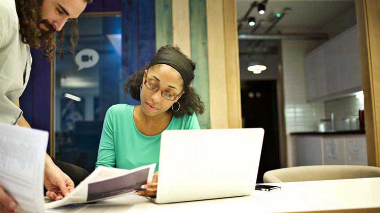 Couple looking at IRA documents to decide if an IRA transfer is right for them.