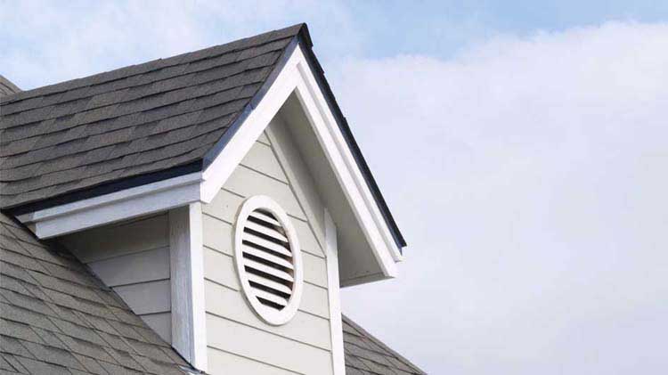 An attic gable with a circular vent.