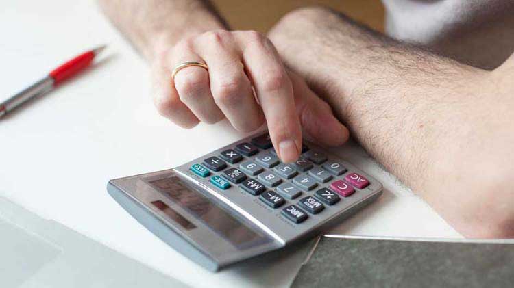 Person working on a calculator.