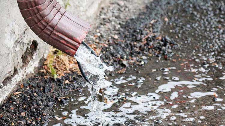 Water pouring out of a downspout