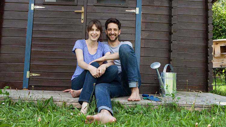 Young barefoot couple in backyard