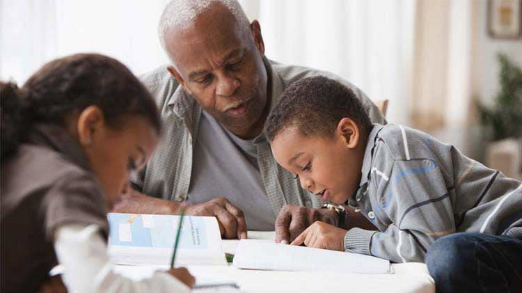 Man doing school work with children at the table.