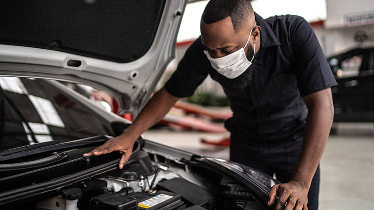 Service technician working on a car with schedule arranged through Openbay