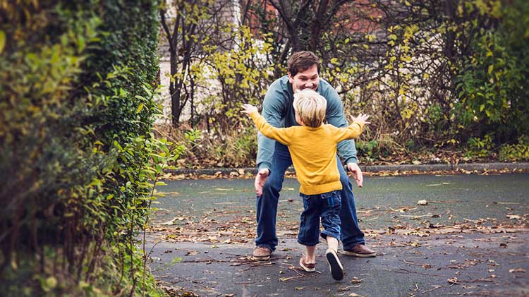 Child running into father’s arms.