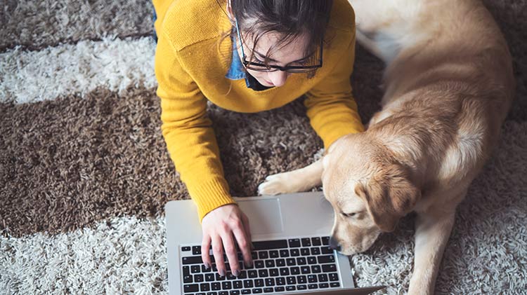 Woman setting up a pet savings account with her dog.