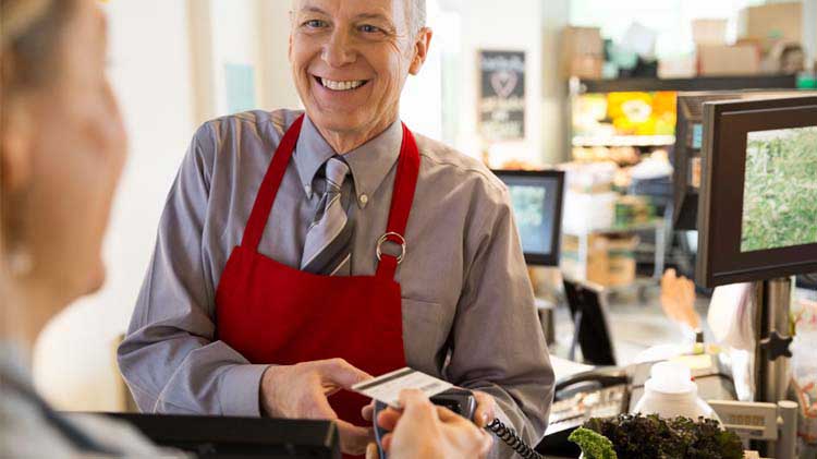 Store owner accepting a credit card at an event.