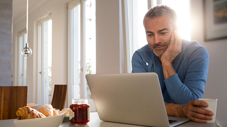 Man reviewing finances on his laptop.