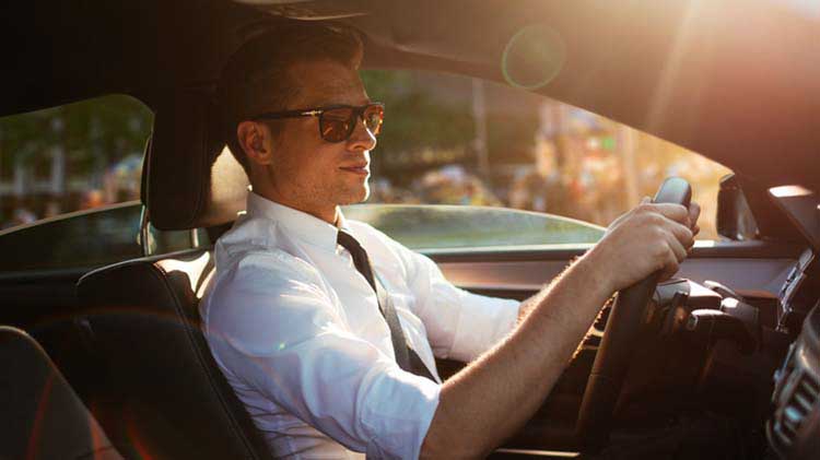 A man driving his car.