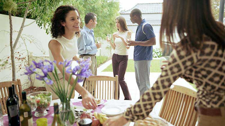 Friends enjoying a house party knowing their home is insured.