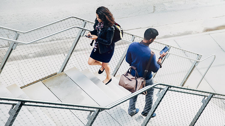 Distracted walkers view their phones while texting and walking.