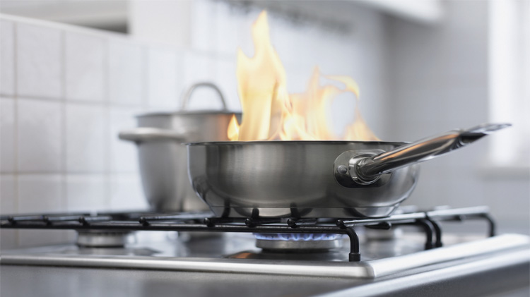 Food burning in a pan on stove.