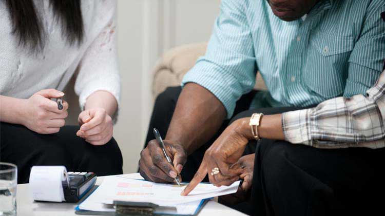 Couple signing a rental lease.