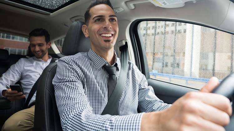 Person enjoying a safe ride from an Uber driver.