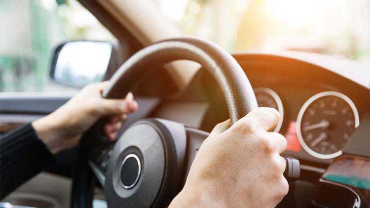 Hands on wheel of a vehicle.