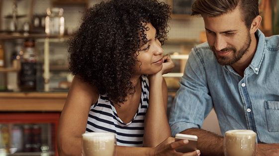 Newly married couple discussing single vs. married health insurance.