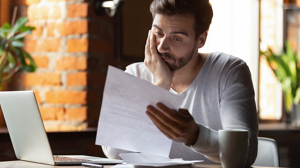 Man reviewing student loan paperwork.