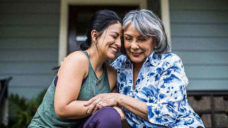 Mother and daughter embracing after discussing wealth transfer.