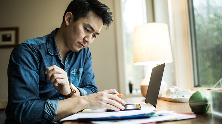 Man reviewing finances with his laptop.