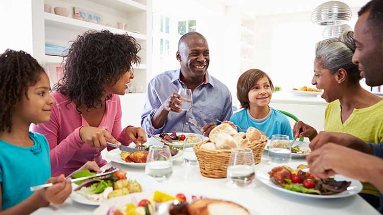 Family eating a meal together at a table.