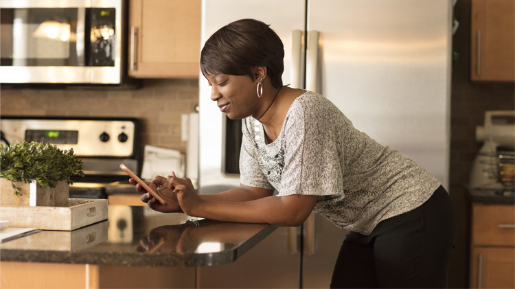 Woman using smartphone to opt in to communications.