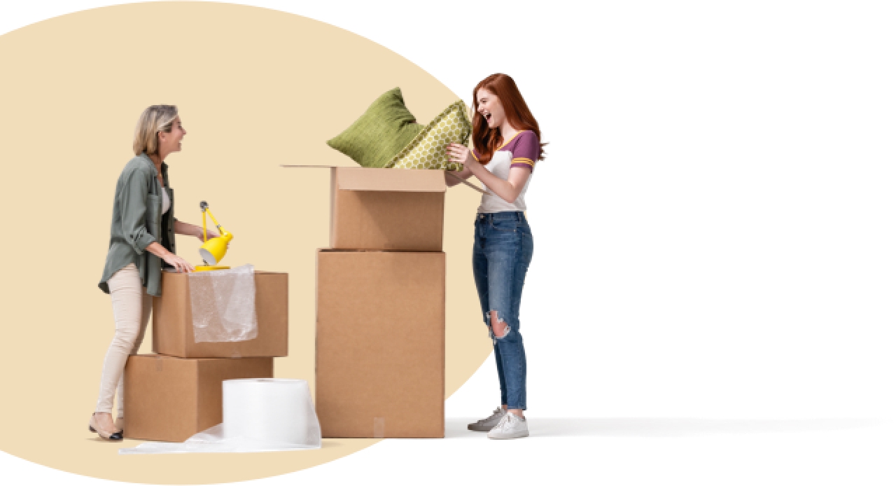 Moving to her new apartment, a daughter laughs over packing green throw pillows into boxes. Her grinning mother holds a yellow desk lamp.